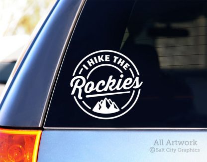 I Hike the Rockies Decal (with Mountains) in White (shown on SUV window)